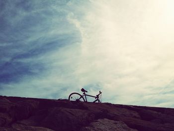 Bicycle on mountain against sky