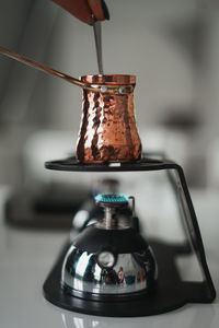 Close-up of hand pouring wine in glass