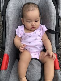 Cute baby girl sitting on seat