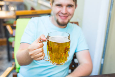 Portrait of a young man drinking glass