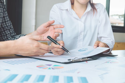 Midsection of woman working on table