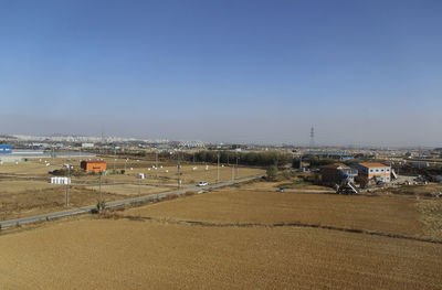 Scenic view of agricultural field against clear sky