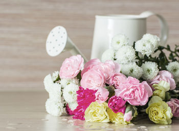 Close-up of pink roses on table