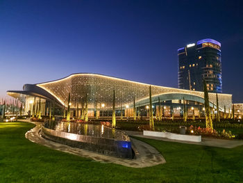 Illuminated modern building against clear sky at night