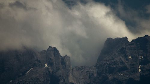 Scenic view of mountains against cloudy sky