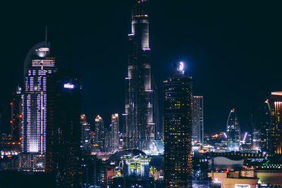 View of skyscrapers lit up at night