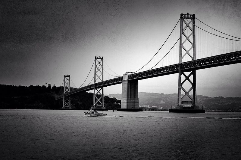 connection, suspension bridge, bridge - man made structure, engineering, built structure, transportation, architecture, clear sky, silhouette, river, water, bridge, travel destinations, international landmark, travel, copy space, waterfront, sky, famous place