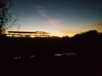 Silhouette trees against sky at night