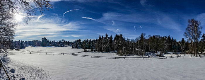 Scenic view of snow covered land against sky