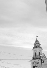 Low angle view of bell tower against sky