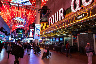 People in illuminated city at night