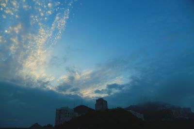 View of cityscape against cloudy sky