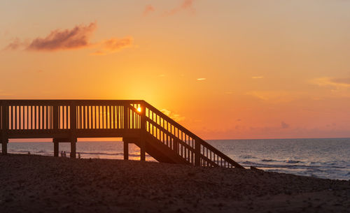 Scenic view of beach against sky during sunset