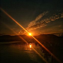 Scenic view of vapor trails in sky during sunset