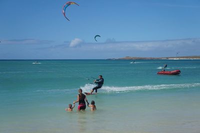 People surfing in sea
