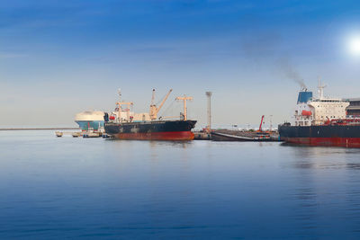 Commercial dock by sea against sky