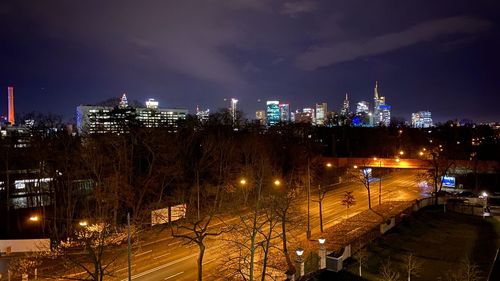 High angle view of illuminated buildings against sky at night