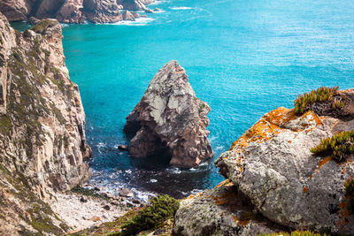 High angle view of rocks at sea shore