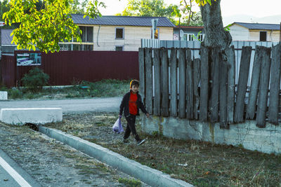 Rear view of woman walking on footpath