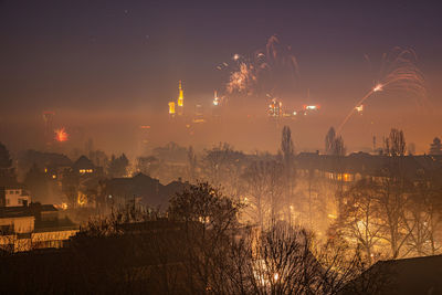 Panoramic view of illuminated city against sky at night