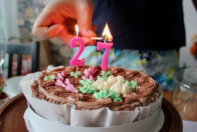 Birthday cake on table with burning candles 