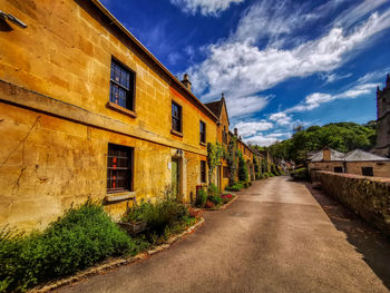 Street amidst buildings against sky