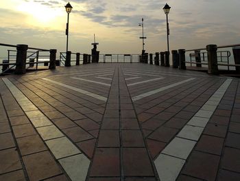 Pier over sea against sky during sunset