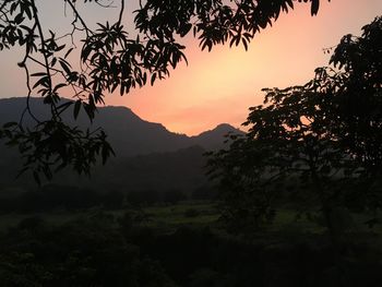 Scenic view of silhouette mountains against sky at sunset