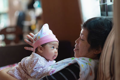 Grandmother playing with granddaughter at home