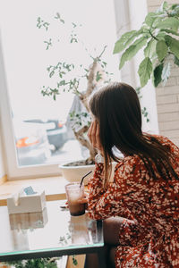 Woman with drink on table