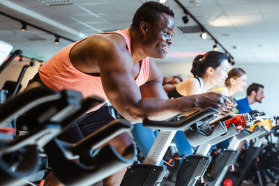 Side view of woman exercising in gym