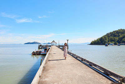 A woman standing on cement pier along over the sea at mu ko phetra in thailand