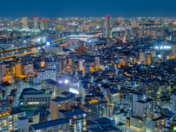 High angle view of illuminated buildings in city at night