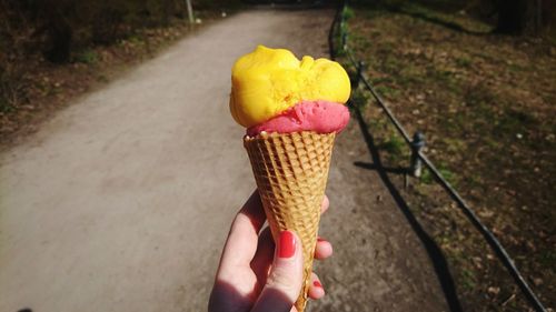 Hand holding ice cream cone