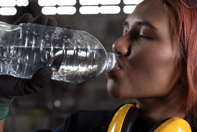 Close-up portrait of young man drinking glass