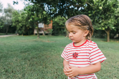 Cute girl looking away on grass