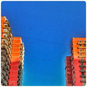 Low angle view of building against clear blue sky