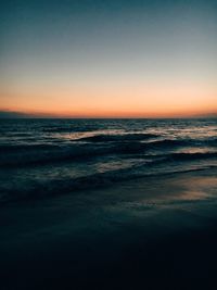 Scenic view of beach at sunset