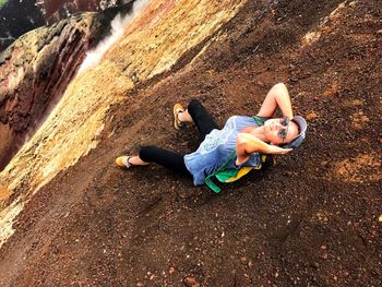 High angle view of mature woman sitting on mountain