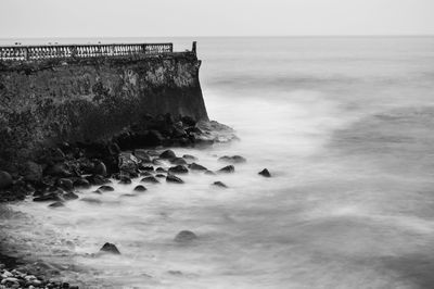 Scenic view of sea by pier