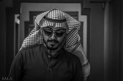 Portrait of young man wearing sunglasses hat