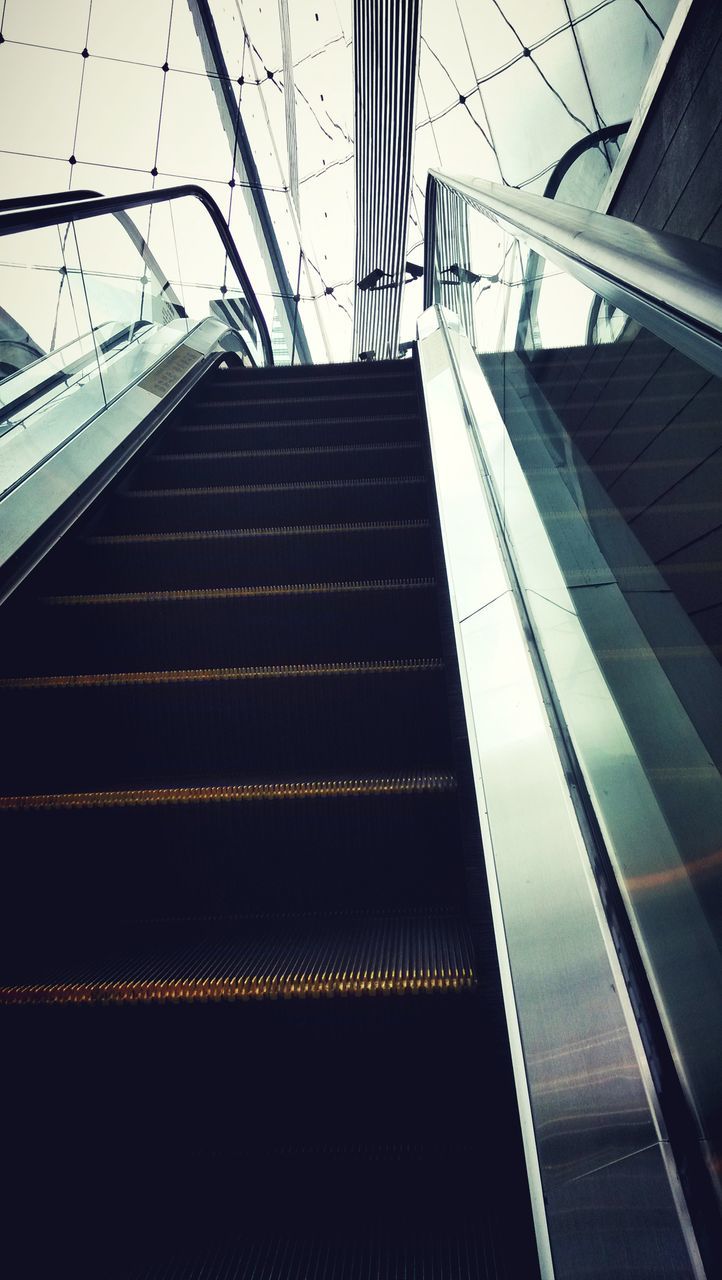 LOW ANGLE VIEW OF ESCALATOR IN SUBWAY STATION