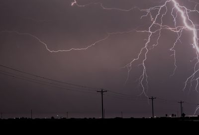 Low angle view of lightning against sky at night