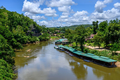 Scenic view of canal amidst trees against sky