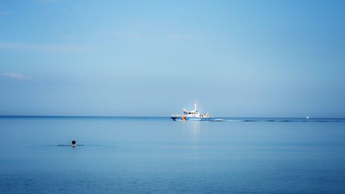 Boat moving on sea against blue sky