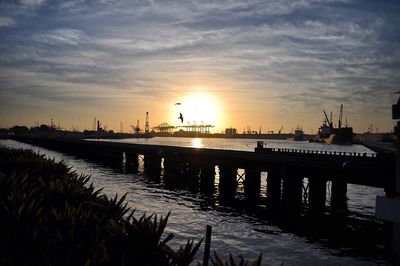 Pier on sea at sunset