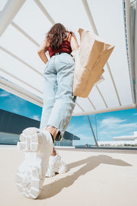 Woman with shopping bag walking outdoors