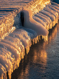 View of frozen ice by lake during winter