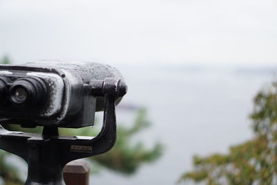 Close-up of coin-operated binoculars against clear sky