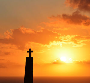 Silhouette lighthouse against sky during sunset